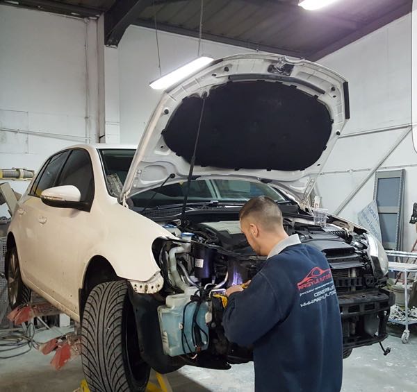 Technician working on a front-end repair